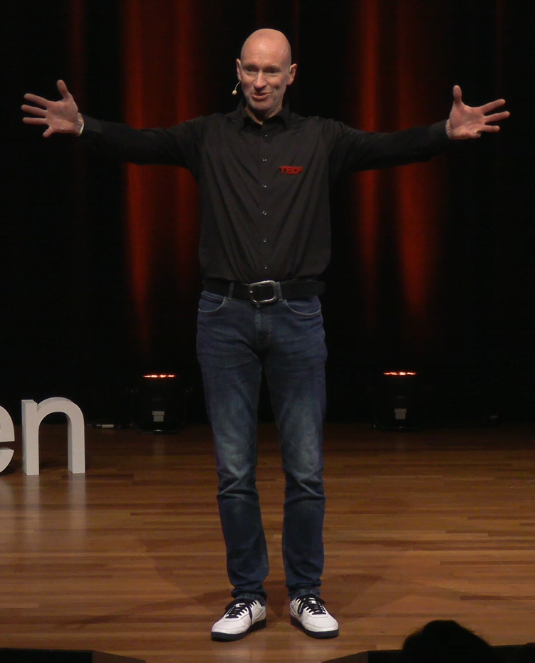 Stefan on the stage with arms wide open